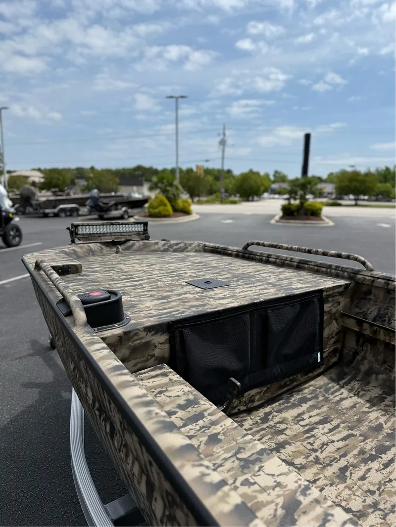 Slide: The Image of 2025 Excel 1651 Viper F4 boat with camouflage design in a parking lot. - 9