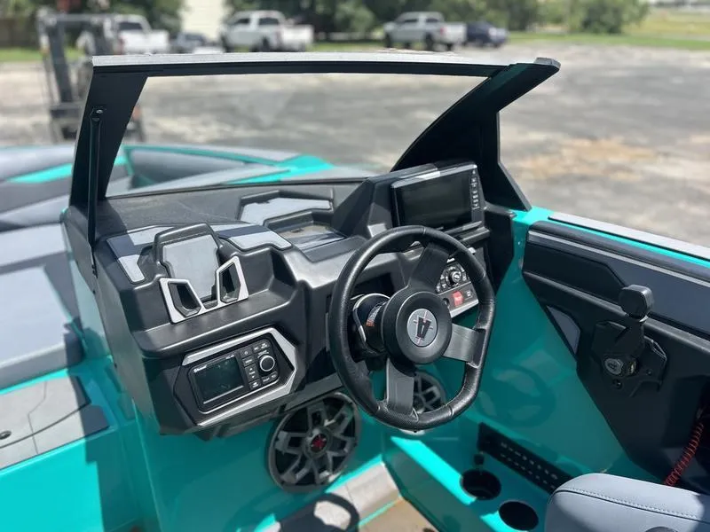 Slide: The Image of 2023 Axis A225 boat dashboard with steering wheel and control panel, featuring modern design. - 6