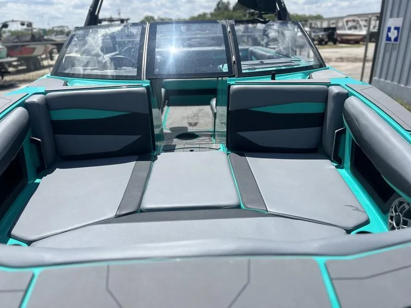 Slide: The Image of 2023 Axis A225 boat interior with gray and teal seating, showcasing modern design. - 7