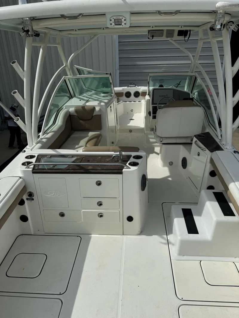 Slide: The Image of 2018 World Cat Glacier Bay Edition 2740 Dual Console boat interior with seating and storage. - 12