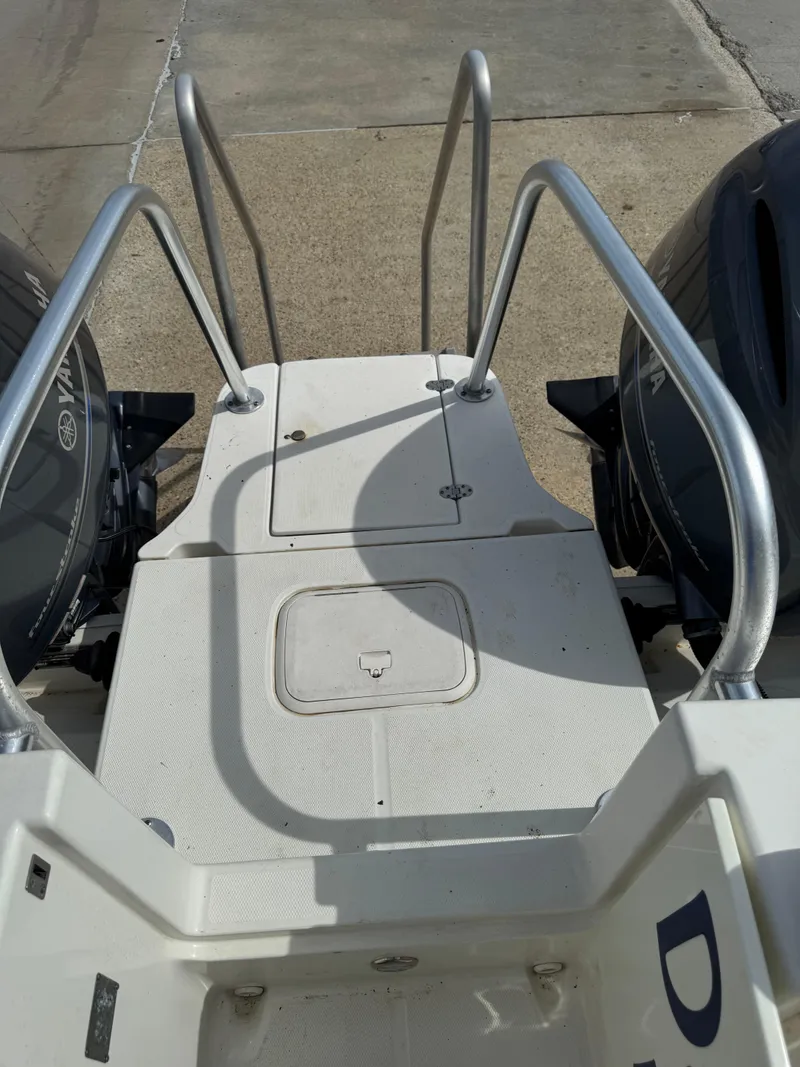 Slide: The Image of 2018 World Cat Glacier Bay Edition 2740 Dual Console boat stern with ladder and twin engines. - 13