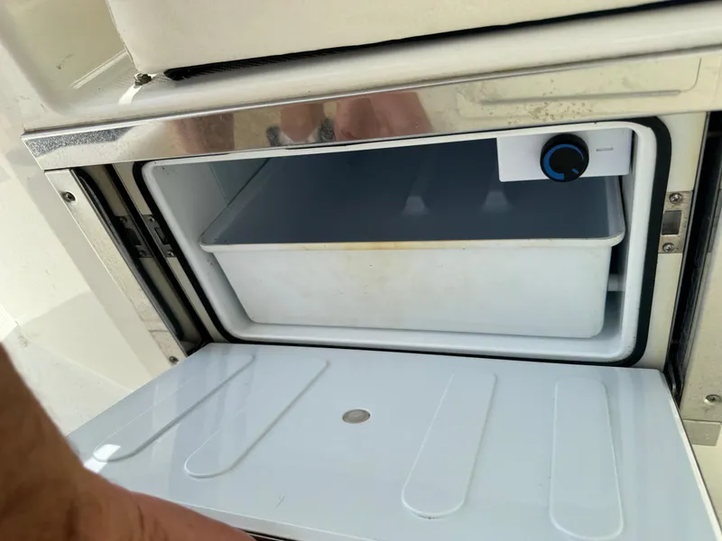 Slide: The Image of Open storage compartment on 2018 World Cat Glacier Bay Edition 2740 Dual Console boat. - 18