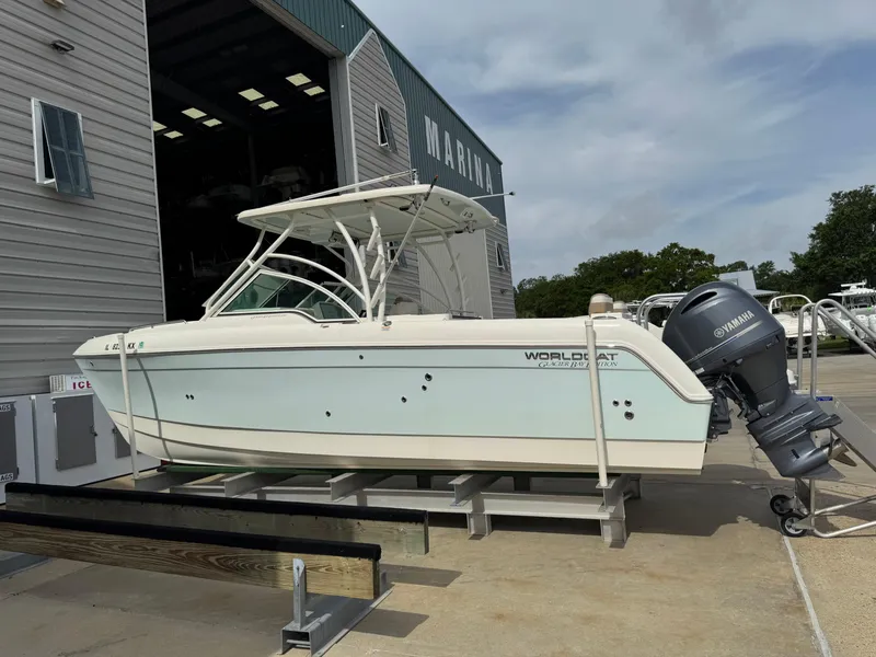 Slide: The Image of 2018 World Cat Glacier Bay Edition 2740 Dual Console boat on trailer at marina. - 2