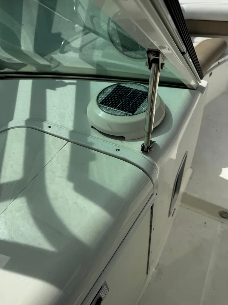 Slide: The Image of 2018 World Cat Glacier Bay Edition 2740 Dual Console boat interior with solar vent detail. - 24