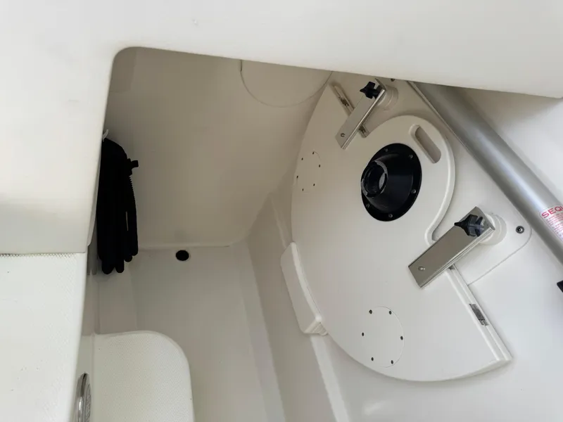 Slide: The Image of 2018 World Cat Glacier Bay Edition 2740 Dual Console interior storage compartment. - 25