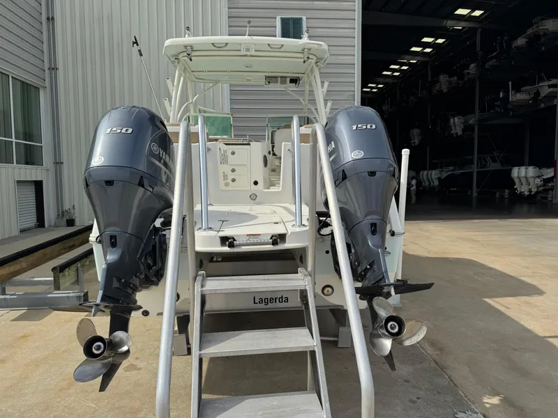 Slide: The Image of 2018 World Cat Glacier Bay Edition 2740 Dual Console with twin 150 engines, docked outdoors. - 26