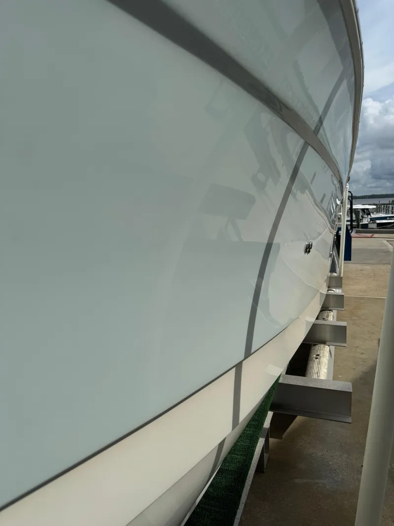 Slide: The Image of 2018 World Cat Glacier Bay Edition 2740 Dual Console boat side view at dock. - 5