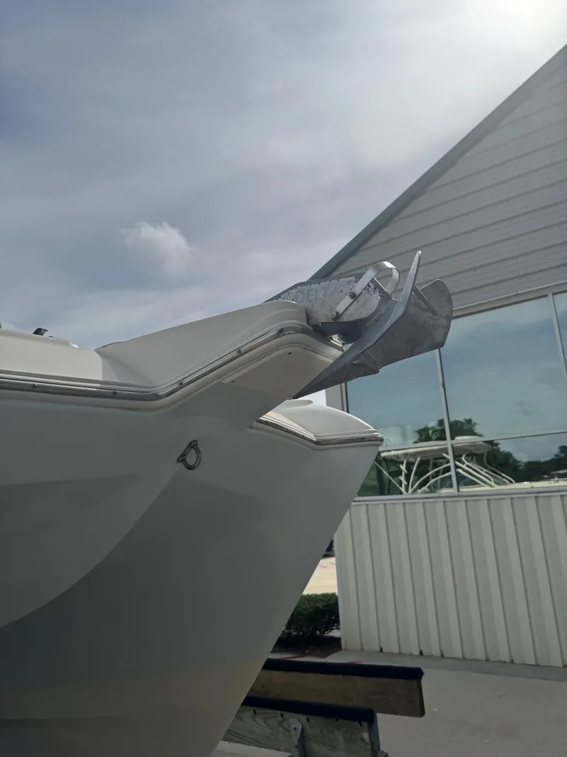 Slide: The Image of 2018 World Cat Glacier Bay Edition 2740 Dual Console boat near a modern building. - 8