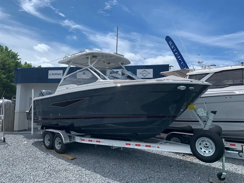 The Image of 2025 Solara S-250 DC boat on trailer, displayed outdoors under a clear sky. - 0