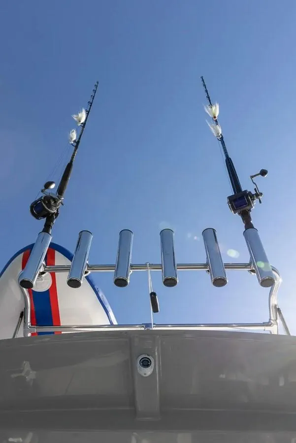 Slide: The Image of 2025 Solara S-250 DC boat with fishing rods against clear blue sky. - 16