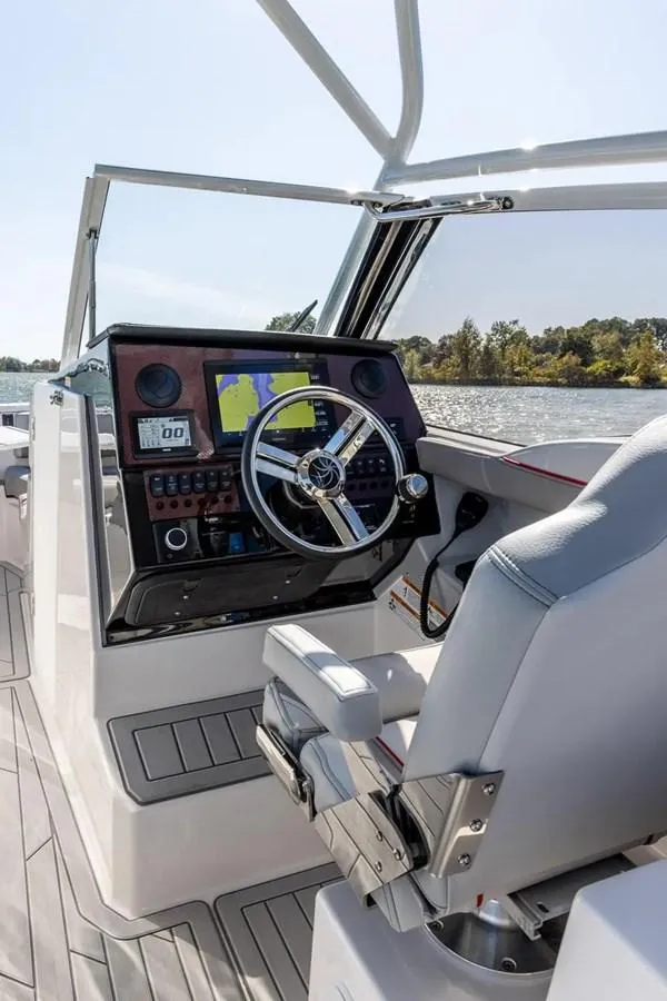 Slide: The Image of 2025 Solara S-250 DC boat cockpit with modern steering and navigation system. - 19