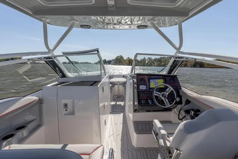 Slide: The Image of 2025 Solara S-250 DC boat interior with modern dashboard and steering on open water. - 22