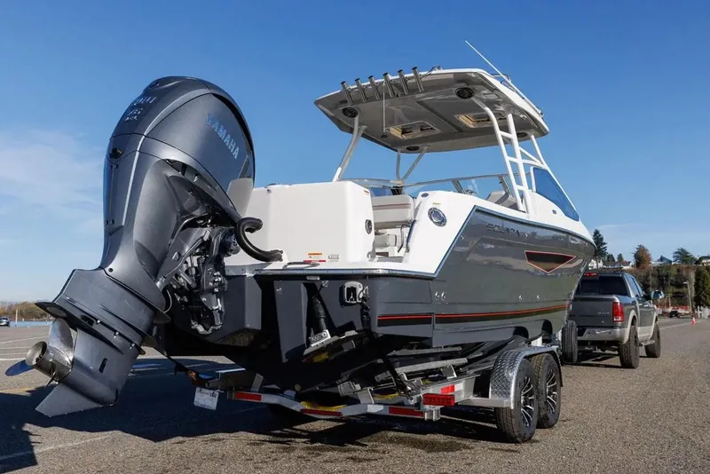 Slide: The Image of 2025 Solara S-250 DC boat on trailer, featuring a powerful outboard motor. - 3