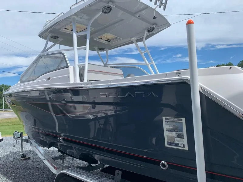 Slide: The Image of 2025 Solara S-250 DC boat with sleek design, docked outdoors under a clear sky. - 5