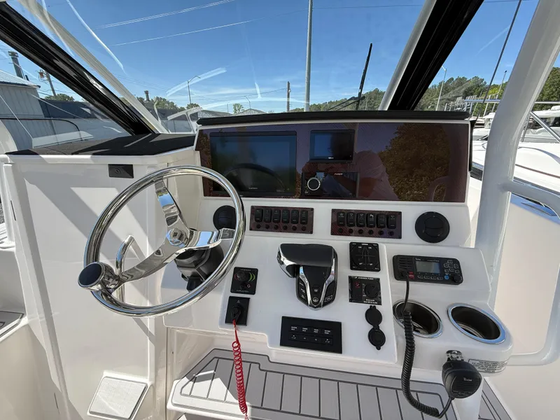 Slide: The Image of 2025 Solara S-250 CW boat dashboard with steering wheel and control panel. - 11