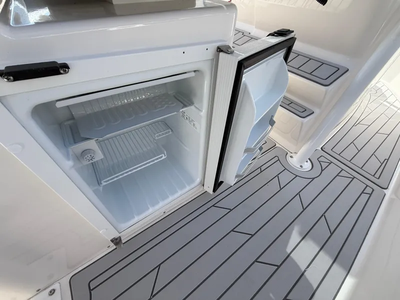 Slide: The Image of Open refrigerator on Solara S-250 CW boat, 2025 model, with sleek deck flooring. - 17