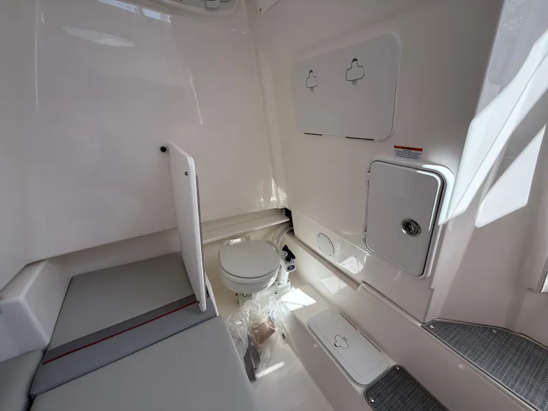 Slide: The Image of 2025 Solara S-250 CW boat interior with compact bathroom and seating area. - 21