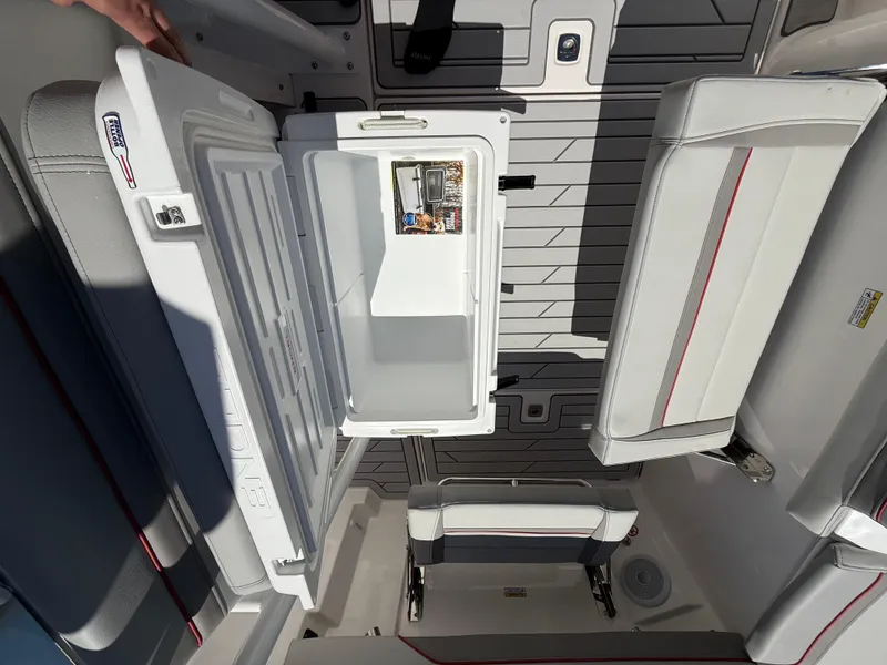 Slide: The Image of Open cooler in Solara S-250 CW boat interior, showcasing seating and storage, 2025 model. - 5