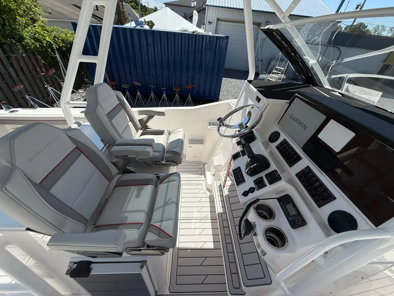 Slide: The Image of 2025 Solara S-250 CW boat cockpit with dual seats and advanced navigation controls. - 9