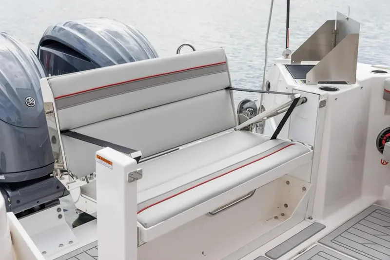 Slide: The Image of 2025 Solara S-310 SC boat with sleek seating and dual outboard motors. - 13