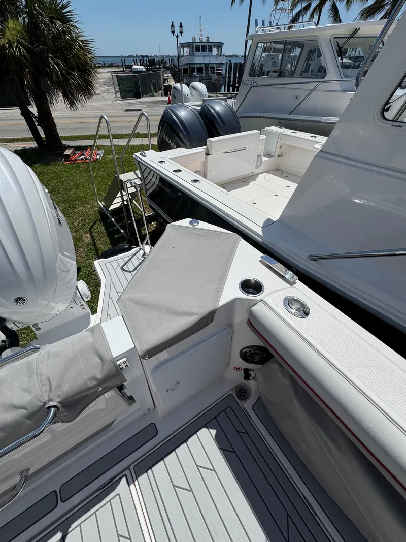 Slide: The Image of 2025 Solara S-310 SC boat with sleek deck design and powerful outboard engines. - 15