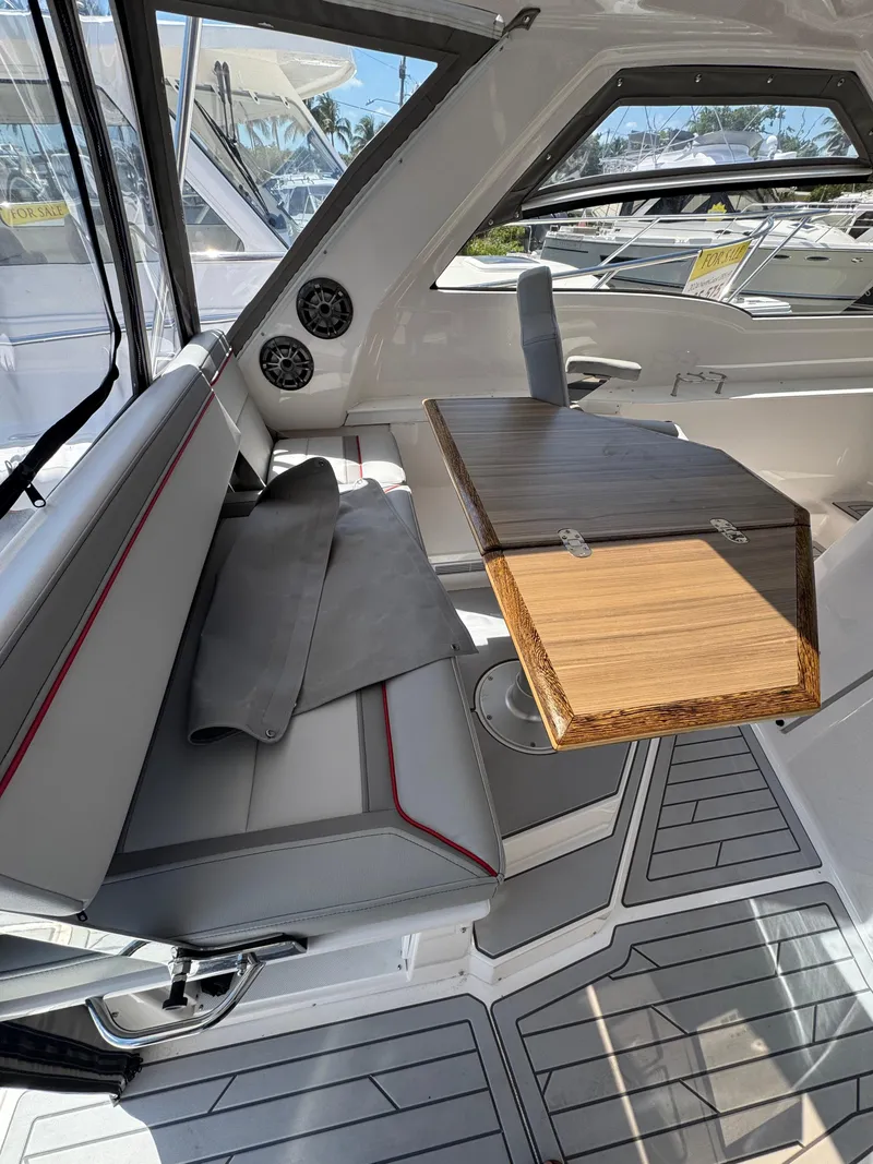 Slide: The Image of Interior of 2025 Solara S-310 SC boat with sleek seating and wooden table. - 18