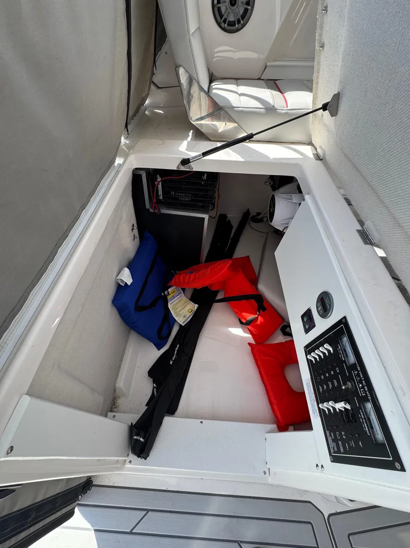 Slide: The Image of Storage compartment in 2025 Solara S-310 SC boat with life jackets and equipment. - 19