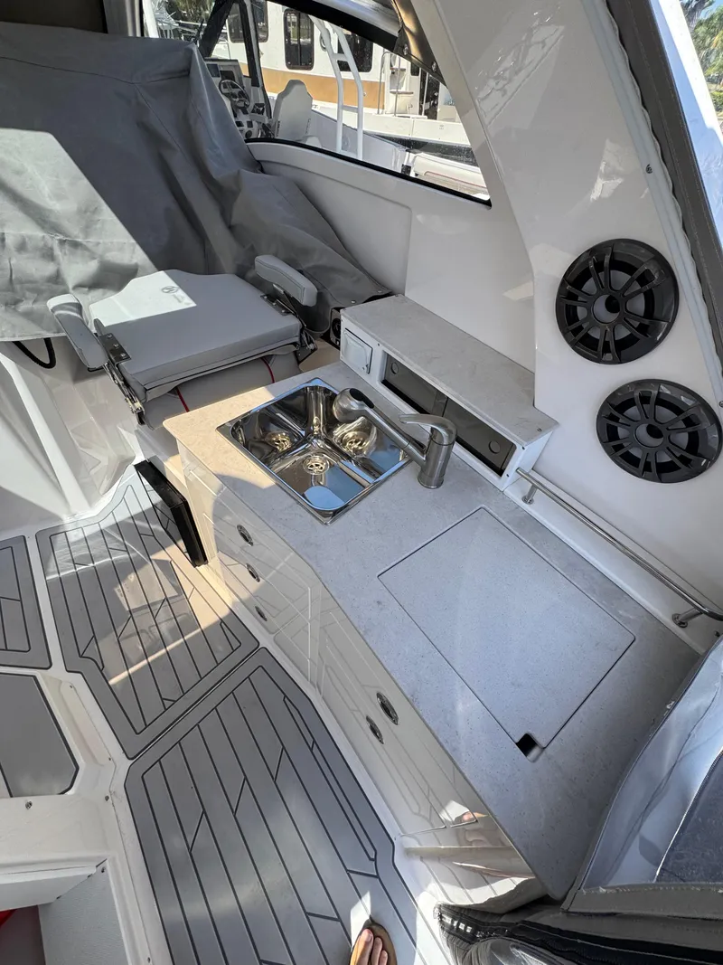 Slide: The Image of 2025 Solara S-310 SC boat interior with kitchenette and seating area. - 20