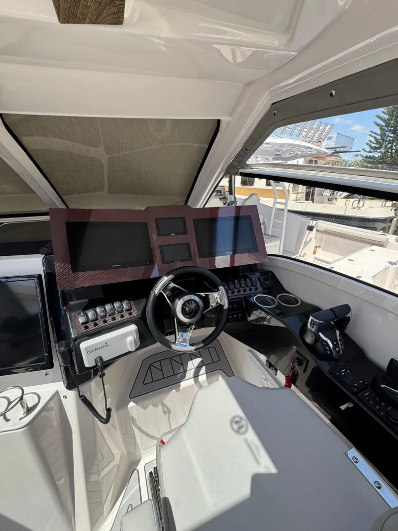 Slide: The Image of Interior cockpit of 2025 Solara S-310 SC boat with modern controls and steering wheel. - 21