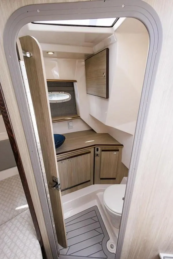 Slide: The Image of 2025 Solara S-310 SC boat interior bathroom with modern fixtures and compact design. - 26