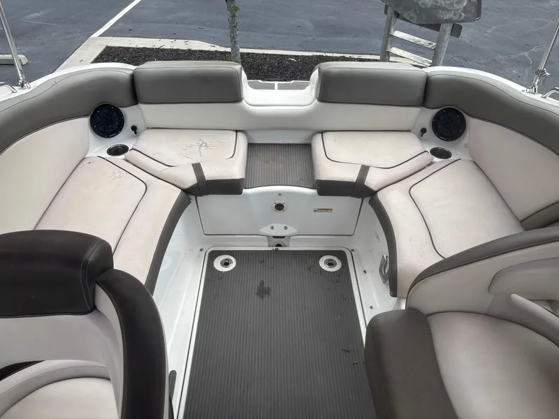 Slide: The Image of 2012 Yamaha Boats 242 Limited interior with cushioned seating and speakers. - 10