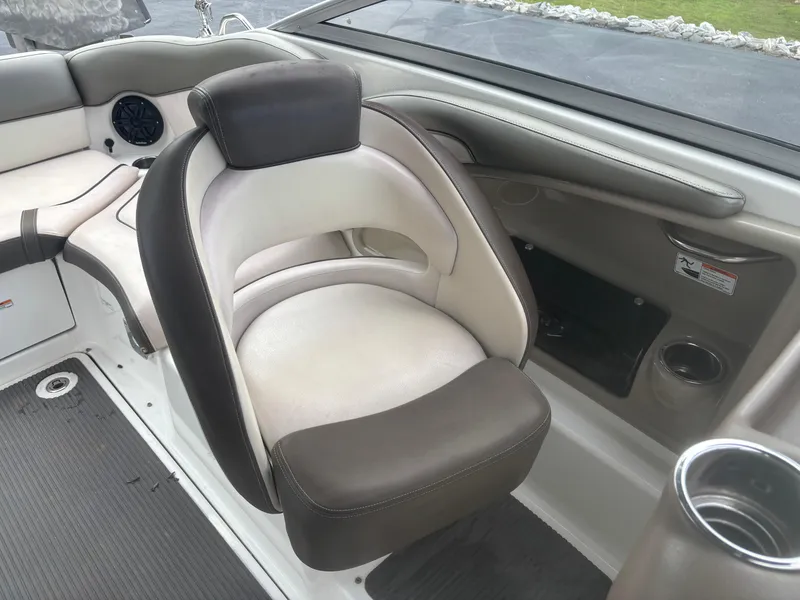 Slide: The Image of 2012 Yamaha Boats 242 Limited interior seating with cup holder and speaker. - 13