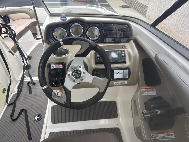 Slide: The Image of 2012 Yamaha Boats 242 Limited dashboard with steering wheel and controls. - 15