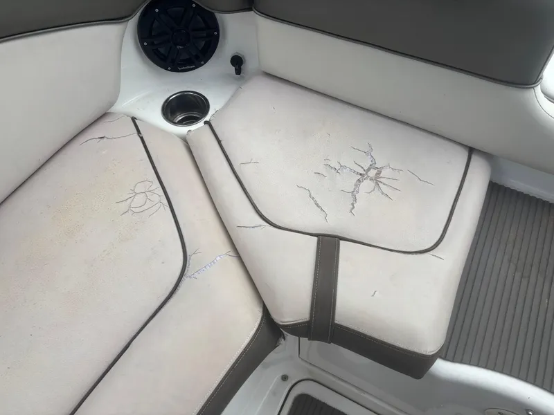Slide: The Image of 2012 Yamaha Boats 242 Limited with cracked upholstery and speaker detail. - 16