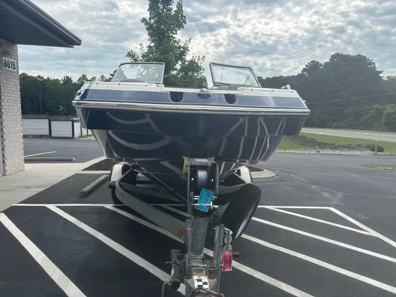 Slide: The Image of 2012 Yamaha Boats 242 Limited on trailer in parking lot. - 3