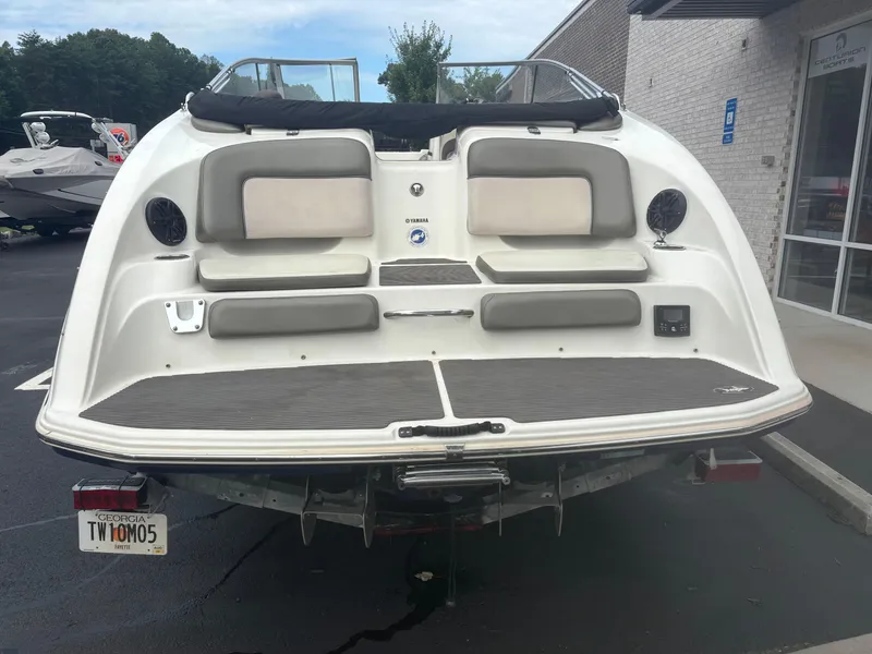Slide: The Image of 2012 Yamaha Boats 242 Limited, rear view, parked on a trailer in a lot. - 5
