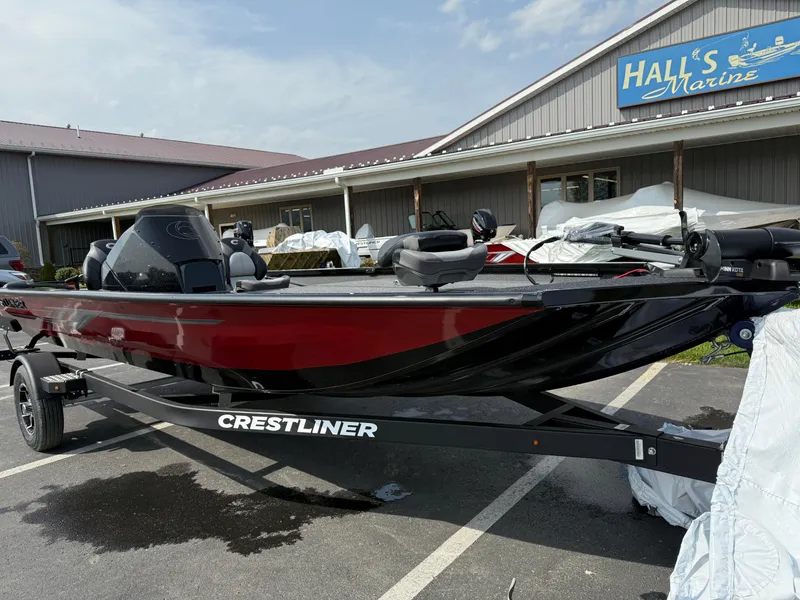 Slide: The Image of 2024 Crestliner XF 189 boat in red and black, parked at Hall's Marine dealership. - 1
