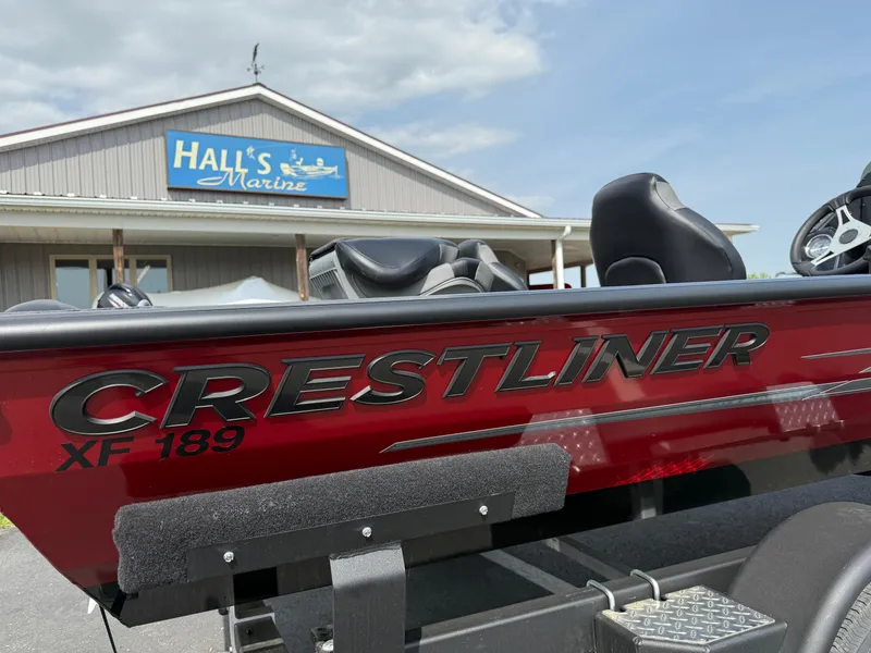 Slide: The Image of 2024 Crestliner XF 189 boat at Hall's Marine dealership, showcasing sleek design. - 2