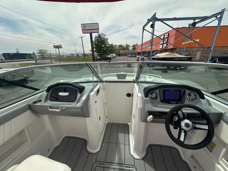 Slide: The Image of 2023 Chaparral 23 SSi boat interior with steering wheel and dashboard controls. - 3