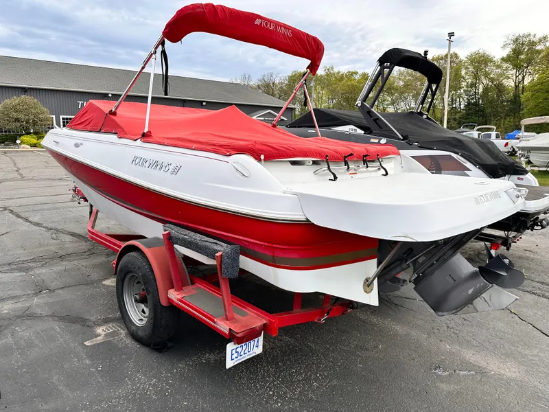 Slide: The Image of 2004 Four Winns 200 Horizon Open Bow boat with red cover on a trailer. - 4