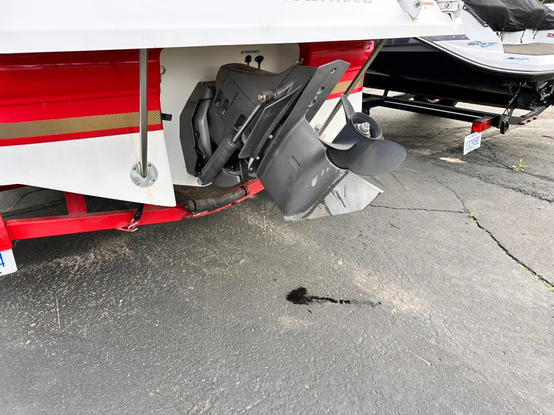 Slide: The Image of 2004 Four Winns 200 Horizon Open Bow boat with visible propeller and red trailer. - 5