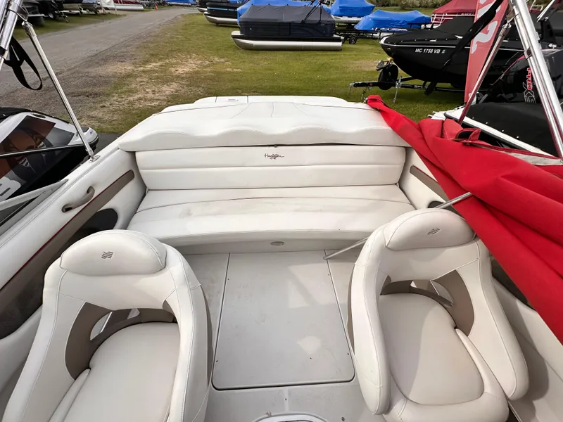 Slide: The Image of 2004 Four Winns 200 Horizon Open Bow boat interior with white seating and red cover. - 9