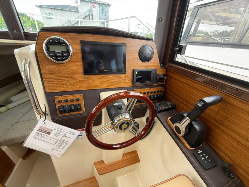 Slide: The Image of Helm of 2025 Ranger Tugs R-23 boat with wooden dashboard and modern controls. - 13