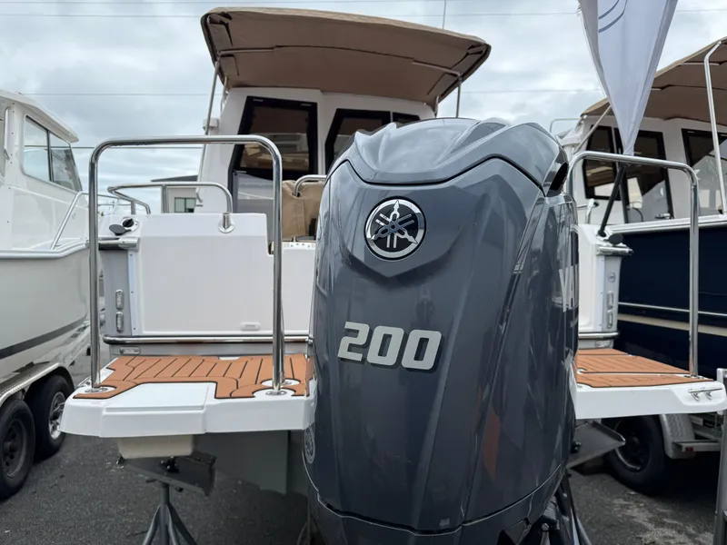 Slide: The Image of 2025 Ranger Tugs R-23 boat with Yamaha 200 outboard motor, docked at marina. - 18