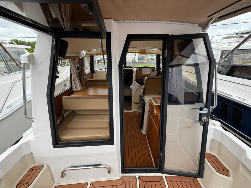 Slide: The Image of 2025 Ranger Tugs R-23 boat interior with teak flooring and seating area. - 8
