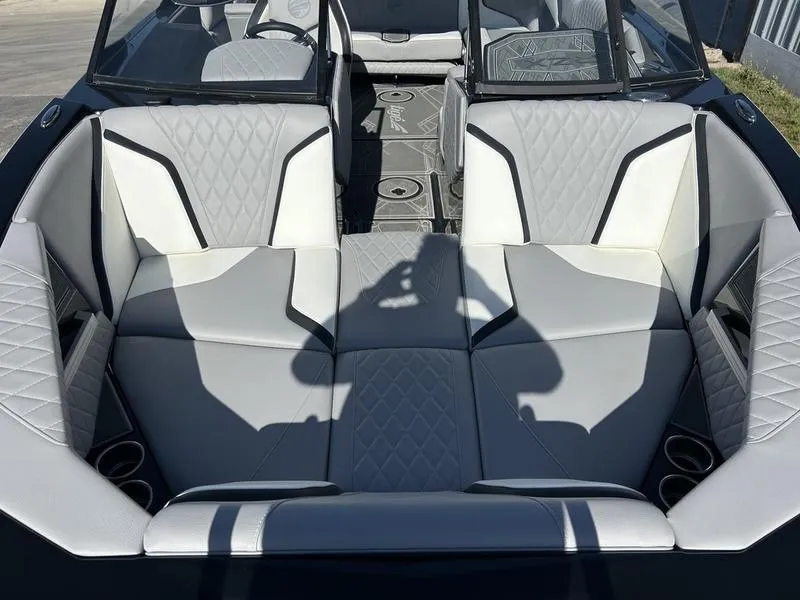 Slide: The Image of 2023 Tigé 22RZX boat interior with luxurious white seating and cup holders. - 2