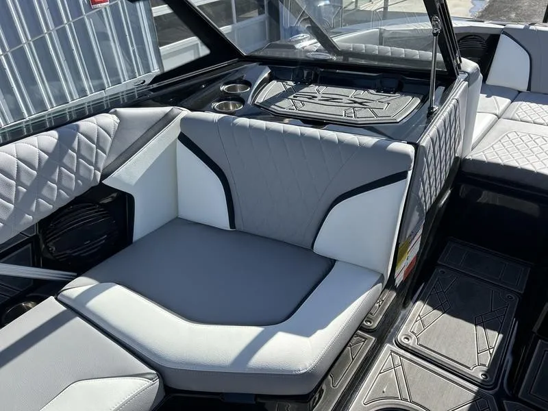 Slide: The Image of 2023 Tigé 22RZX boat interior with gray and white seating, cup holders, and quilted design. - 3