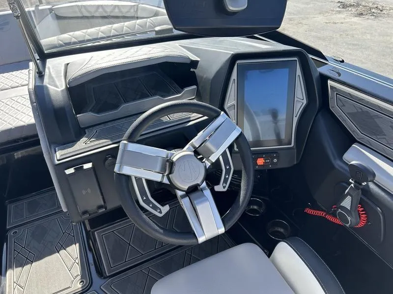 Slide: The Image of 2023 Tigé 22RZX boat dashboard with modern steering wheel and touchscreen display. - 4