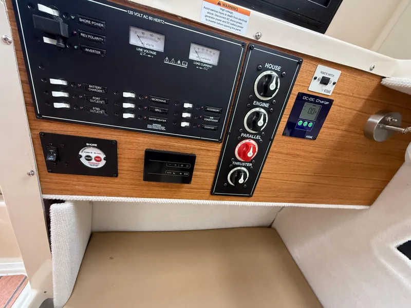 Slide: The Image of Control panel of 2025 Ranger Tugs R-25 boat with switches and gauges. - 13