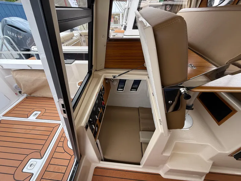 Slide: The Image of 2025 Ranger Tugs R-25 interior with foldable seat and control panel, showcasing modern design. - 14